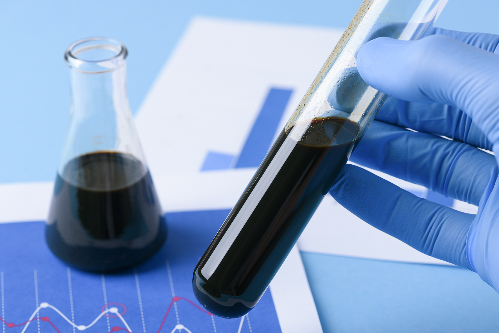 Lab test crude oil in vial in scientist hand